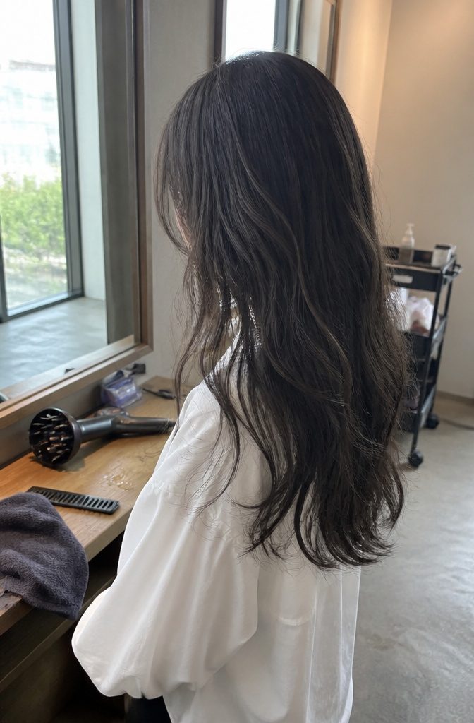Long hair with loose waves and softly moving face-framing bangs