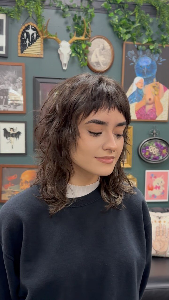 Woman showing a choppy layered shag haircut with short fringe