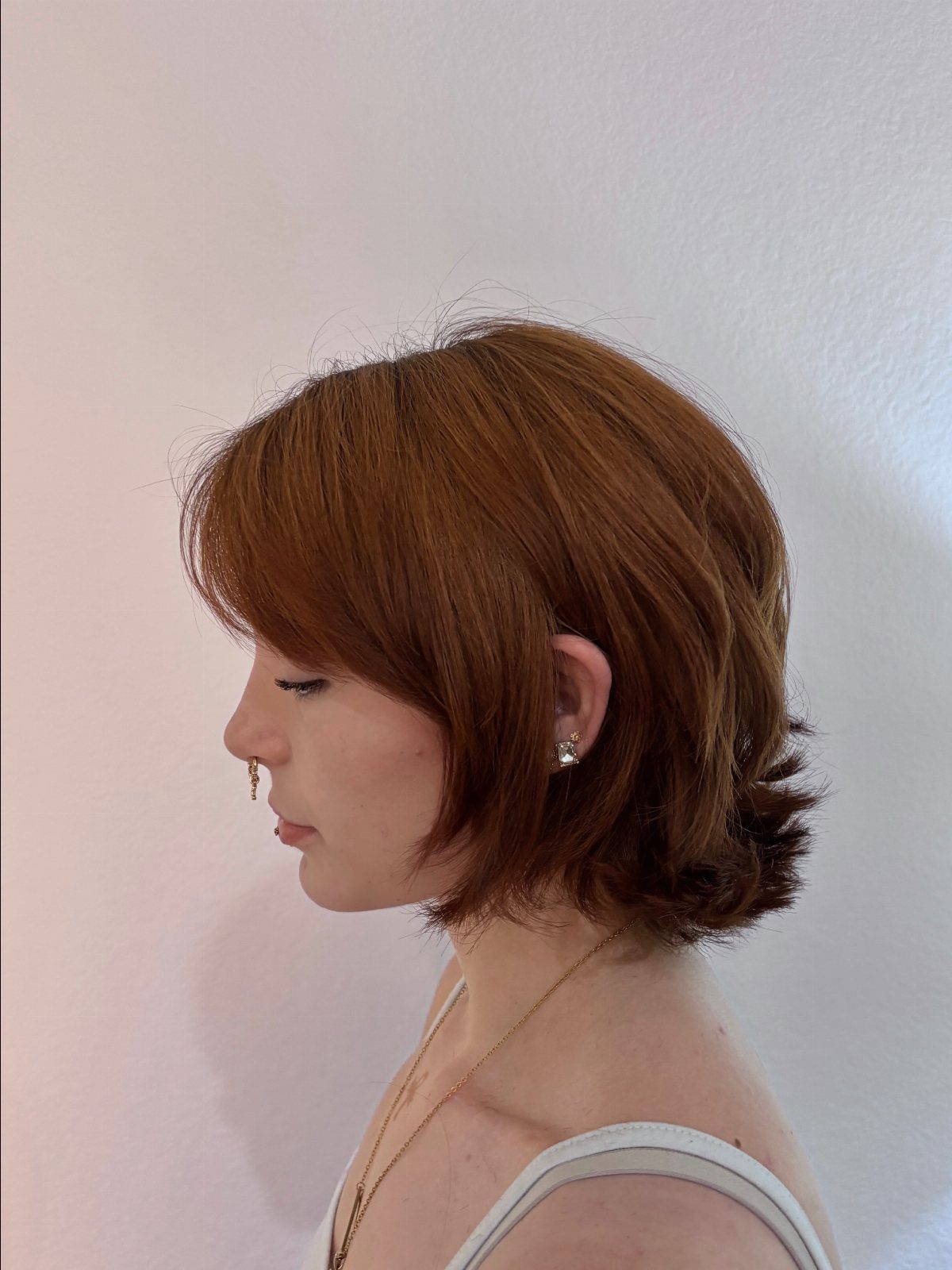Reddish-brown bob with a rounded shape and softly curled ends