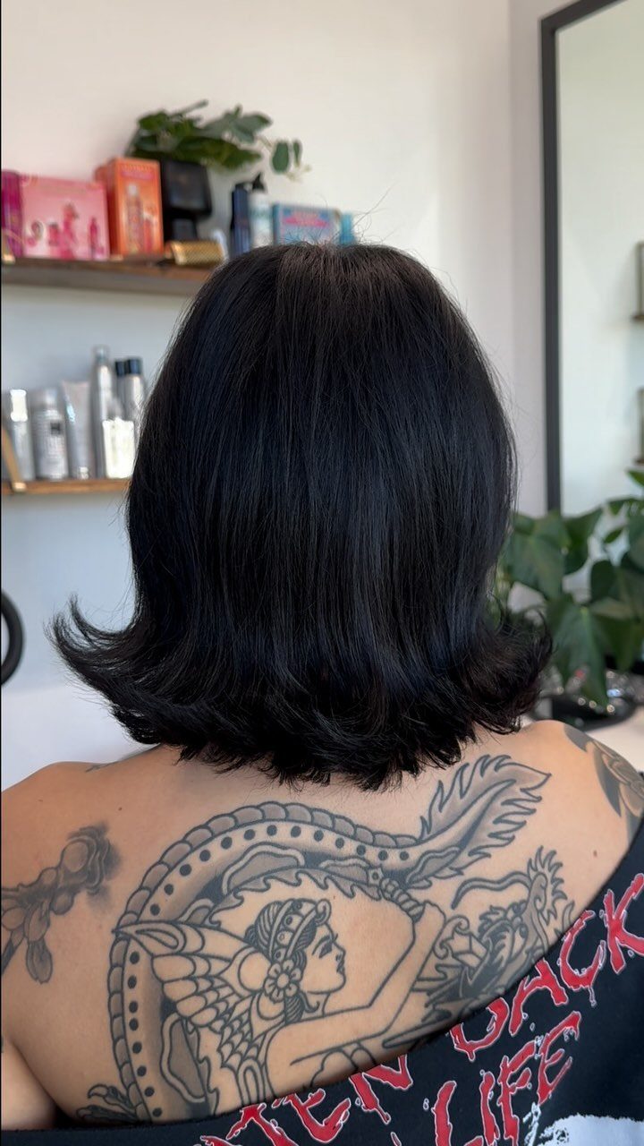 Black bob with layered ends flipping outward in a salon