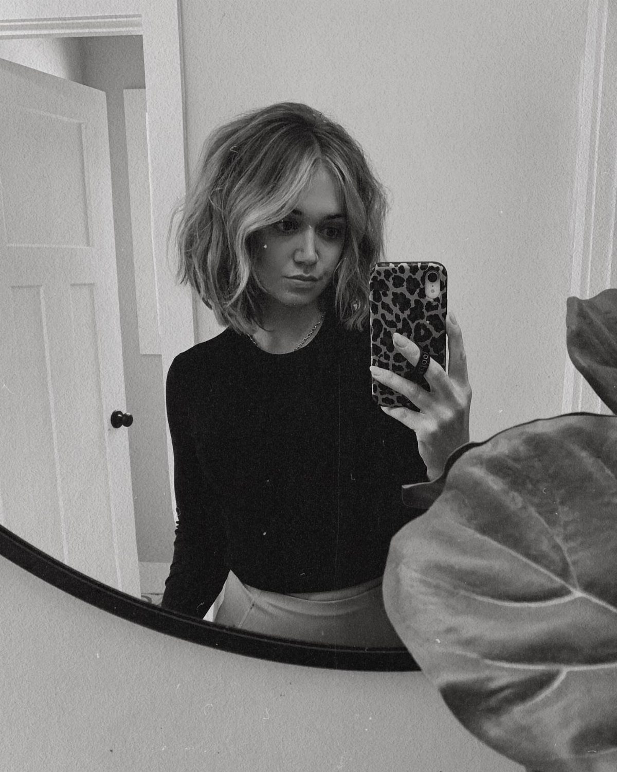 Person shows tousled wavy bob with choppy bangs in a mirror selfie