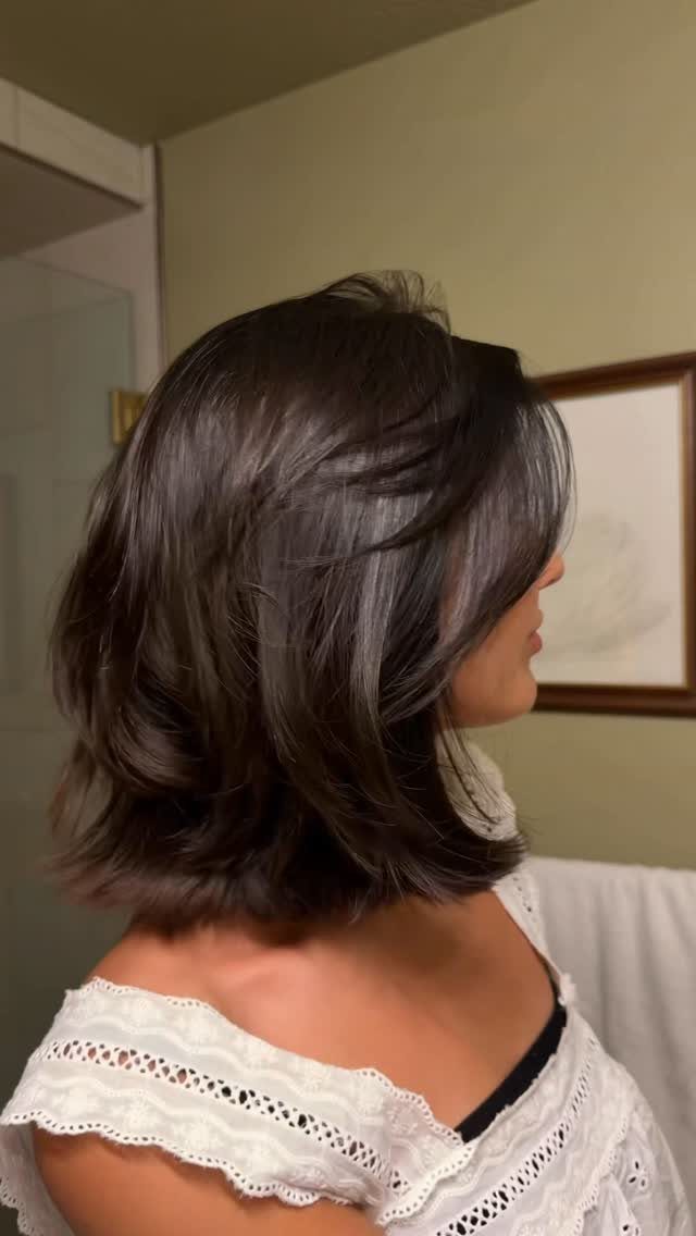 Layered dark brown bob haircut with curled ends, shown from behind