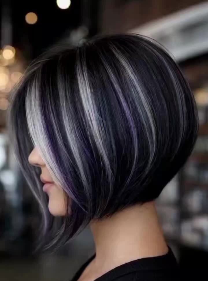Angled dark bob with silver highlights and long side-swept fringe