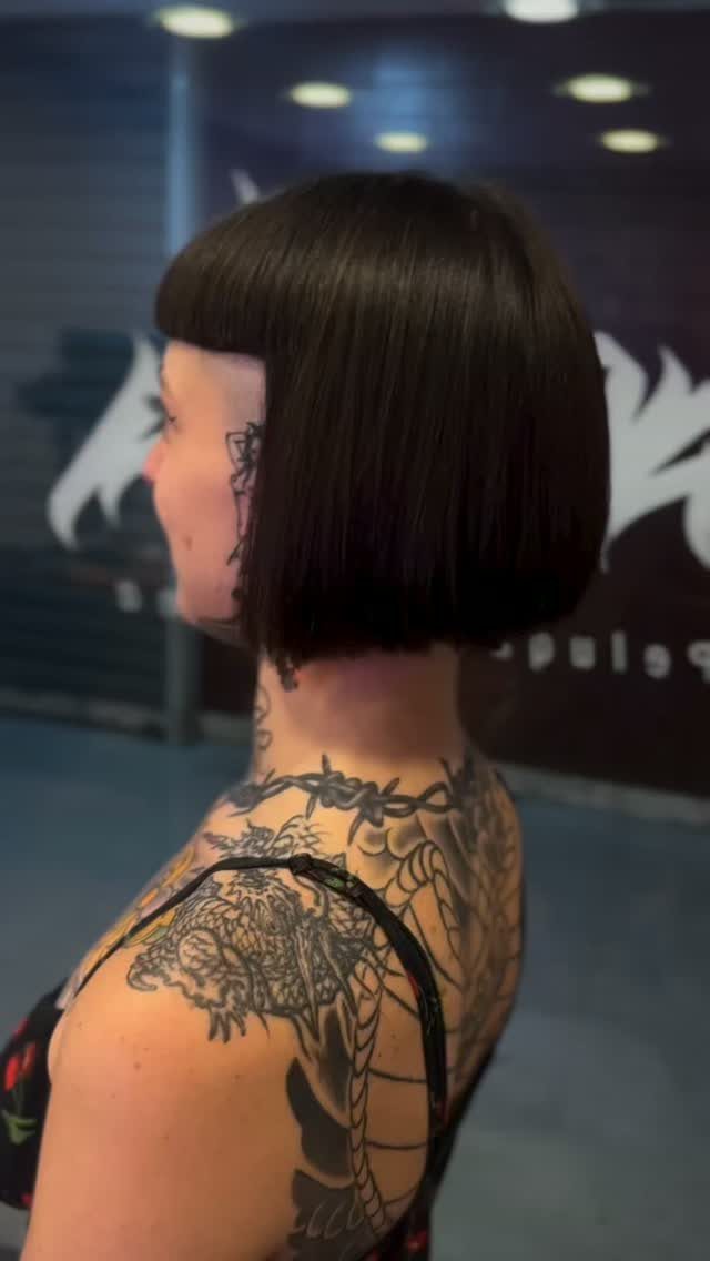 Blunt black jaw-length bob with very short straight bangs