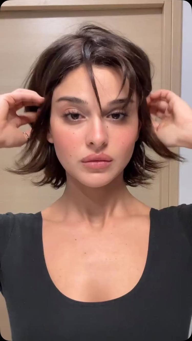Woman showing a tousled short bob with textured waves and wispy bangs
