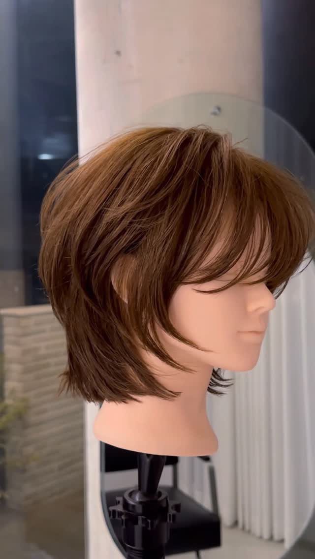 Brown short bob wig with feathered bangs and textured, layered ends