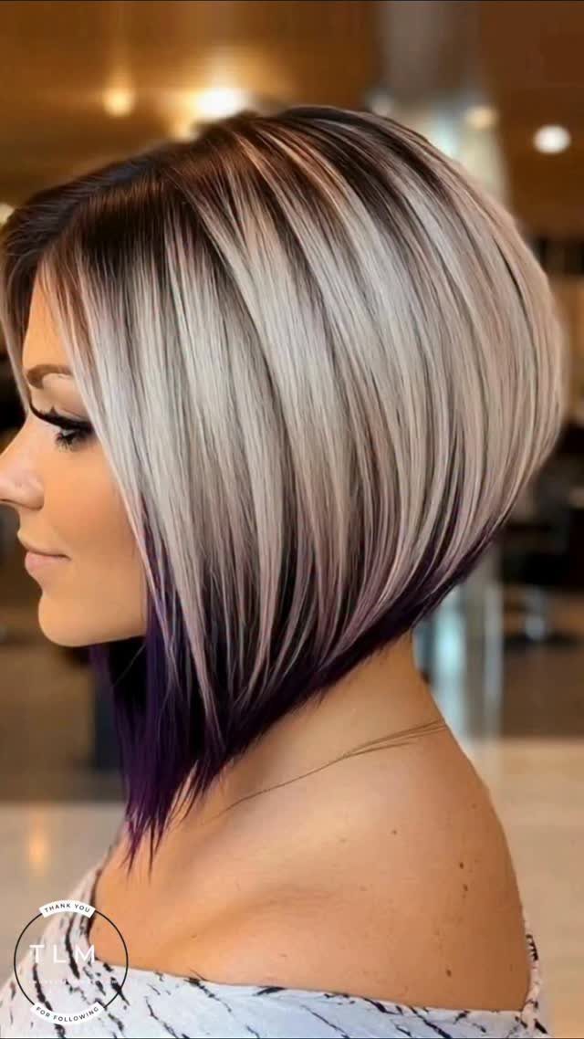 Woman showing a sleek angled silver-gray bob haircut in side profile