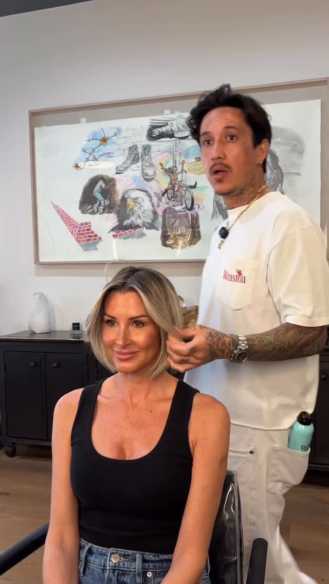 Woman with a chin-length blonde bob seated beside her hairstylist
