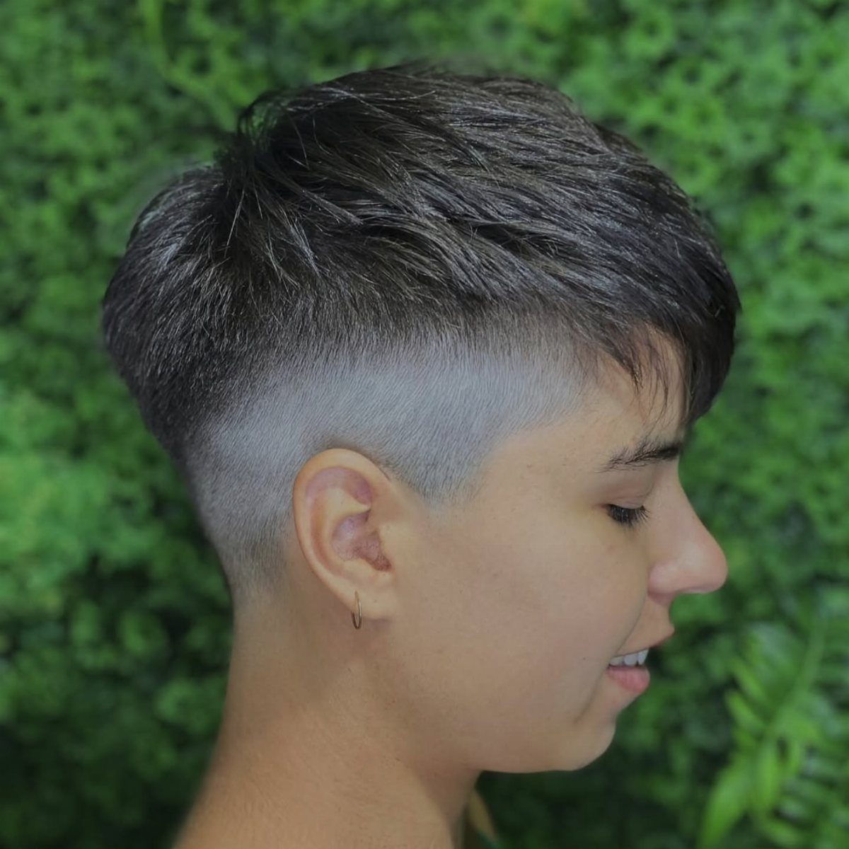 High fade French crop with textured dark hair and a short forward fringe