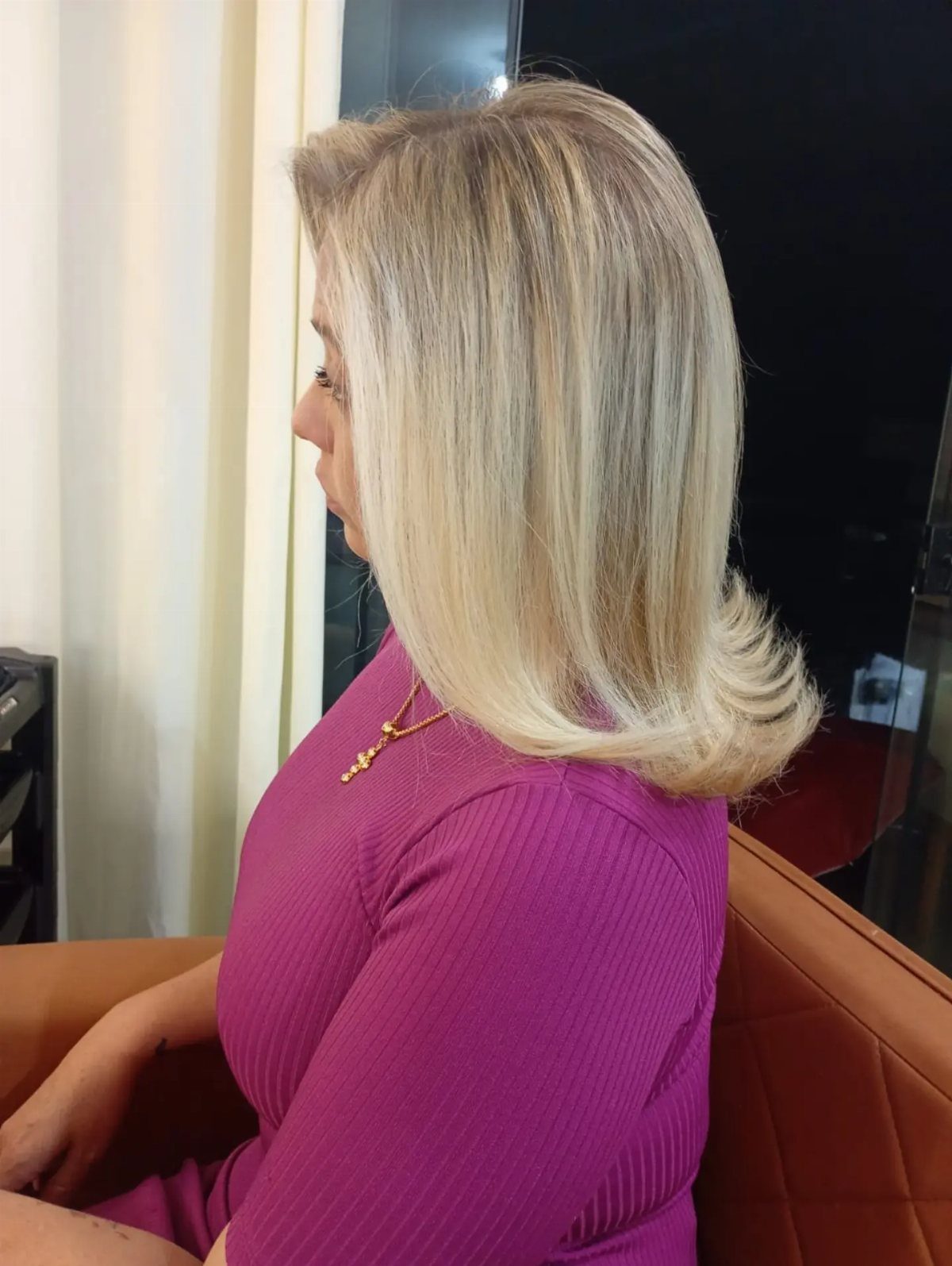 Blonde shoulder-length hair styled with smooth, outward-flipped ends