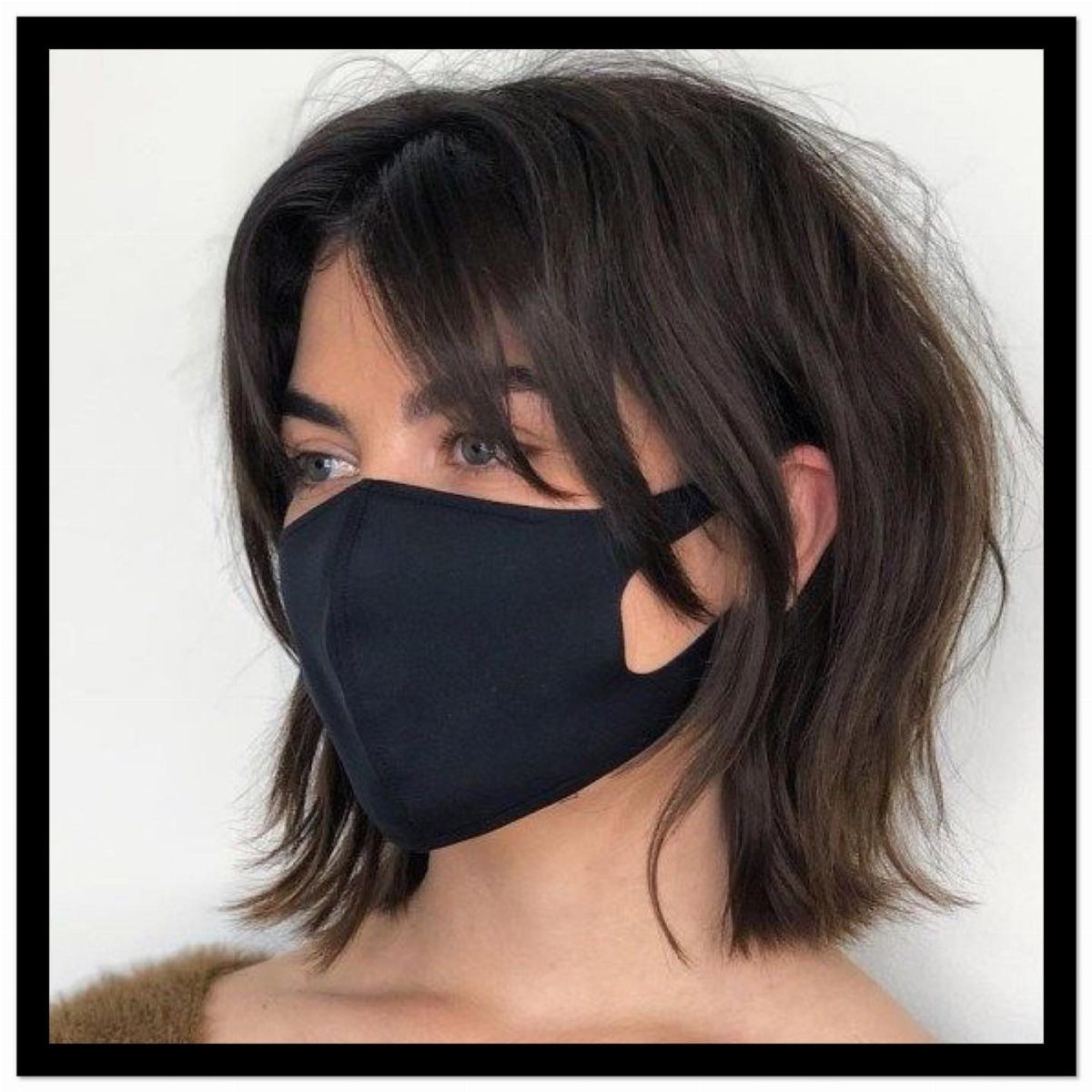 Chin-length dark layered haircut with wispy bangs and textured ends