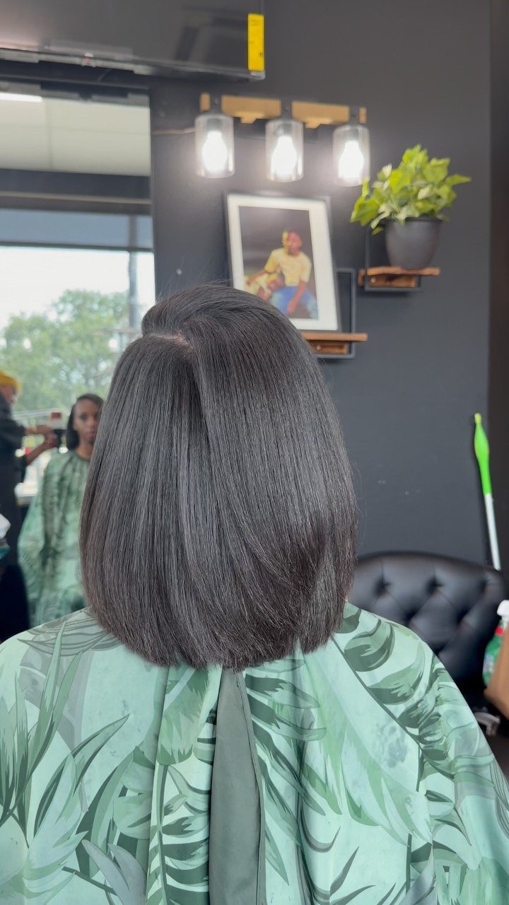 Rounded sleek dark bob with softly layered ends seen from behind