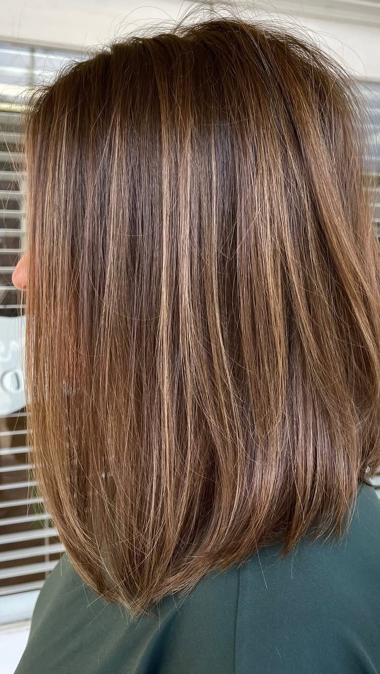 Straight brown blunt lob with subtle highlights and a clean shoulder-length outline
