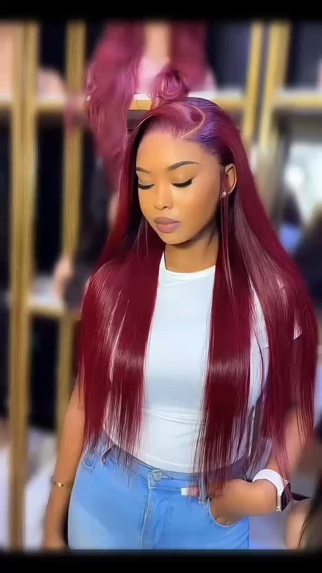 Woman displaying long, straight deep mahogany hair with a soft layered cut