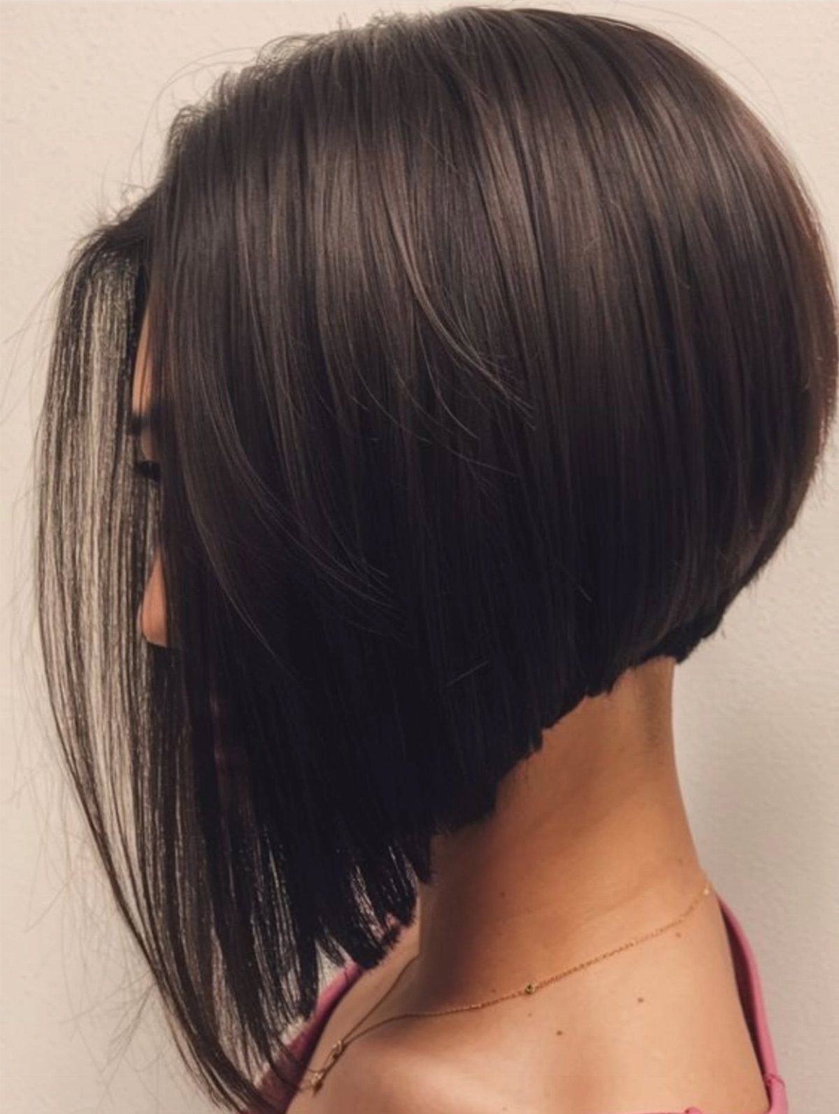 Asymmetrical dark brown bob with a longer front section and shorter back