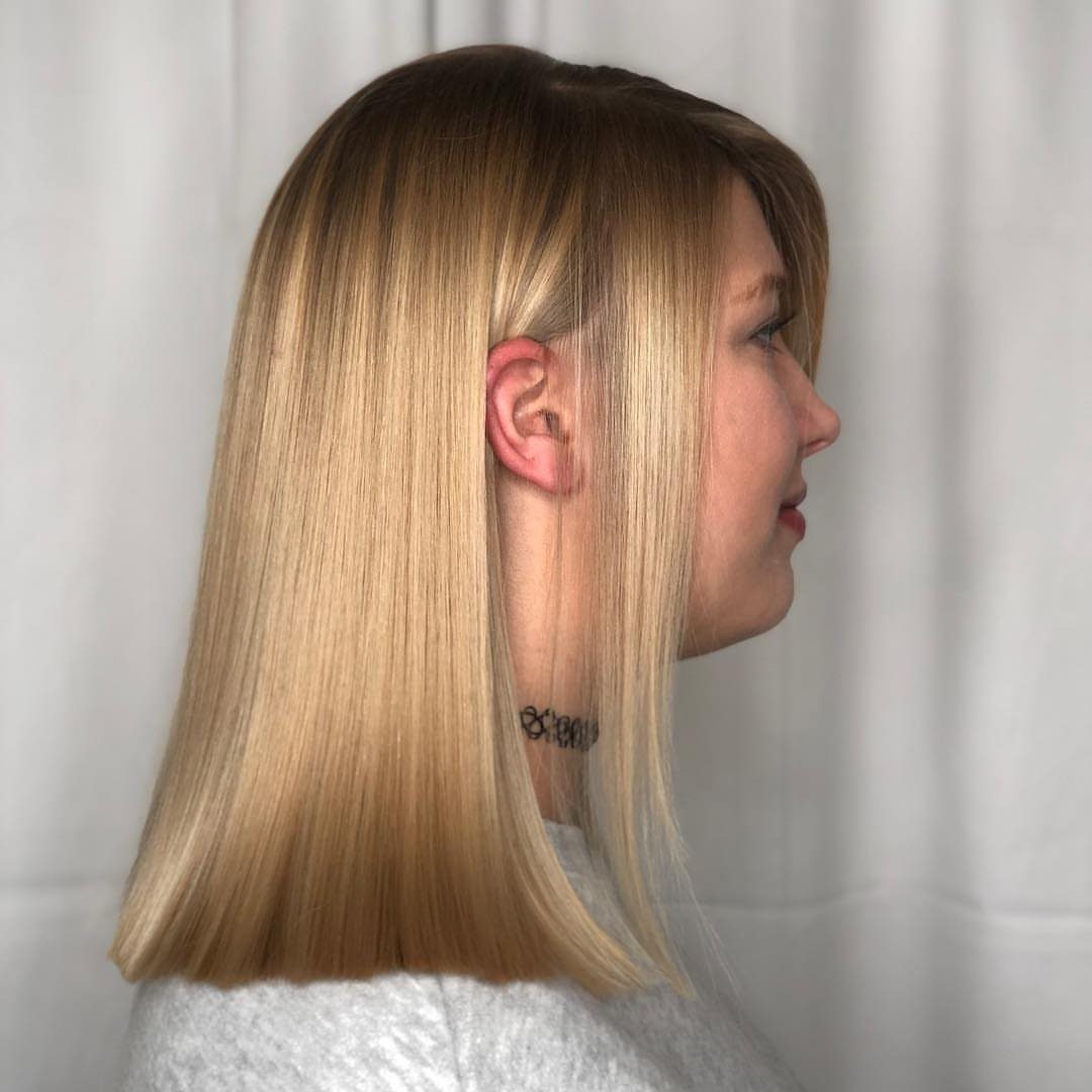Straight blonde shoulder-length hair with a blunt, even cut