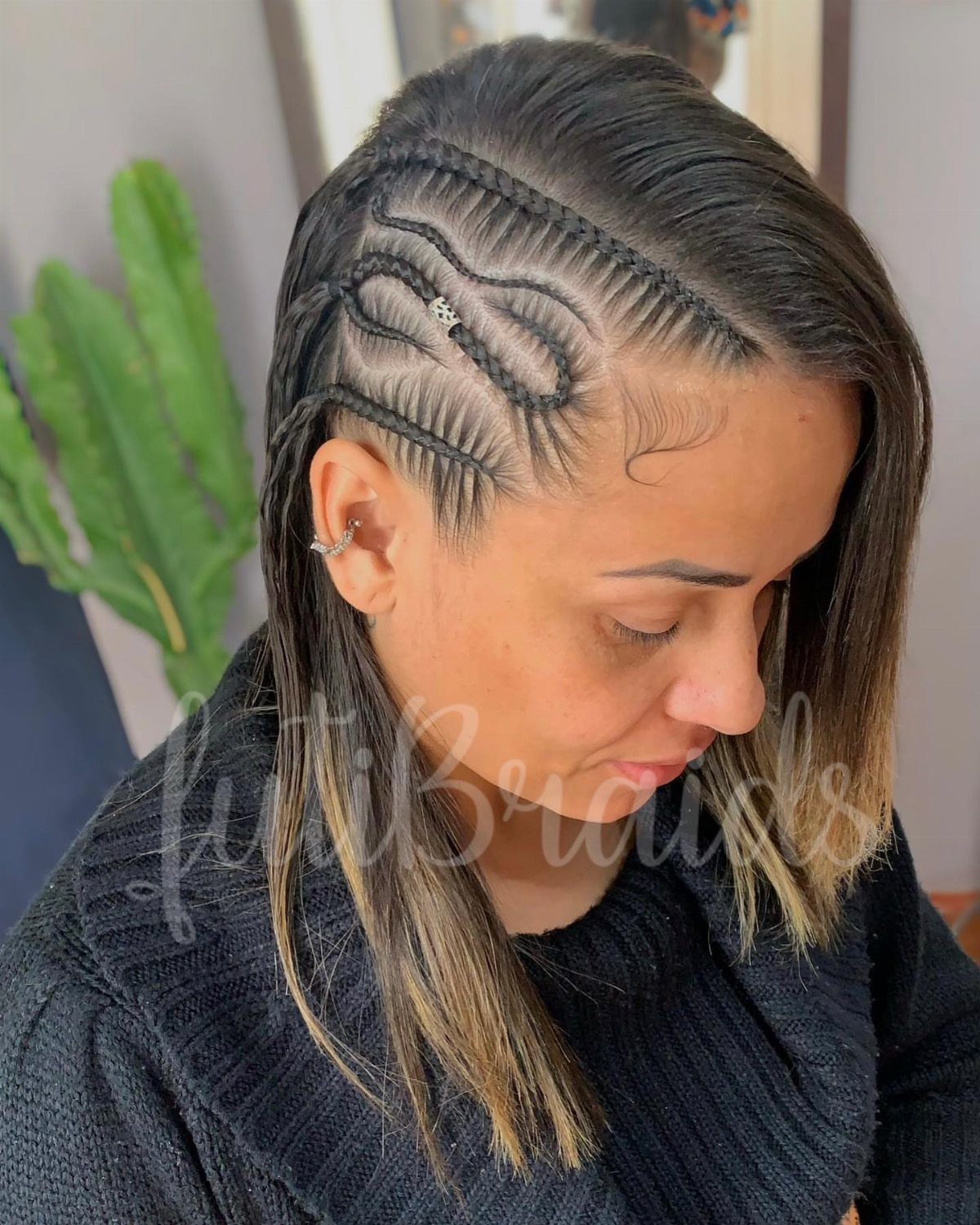 Woman with blonde-ended straight hair and curved braids along a deep side part