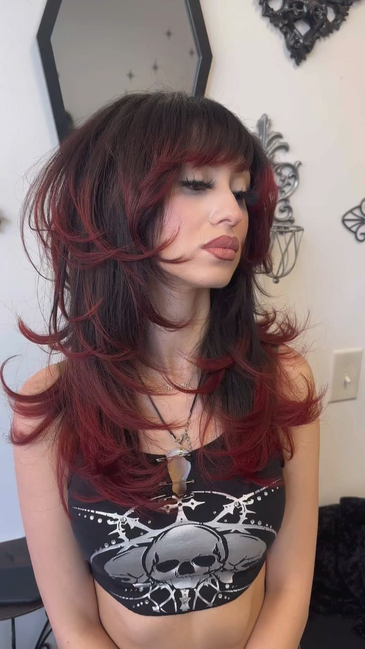 Shoulder-length red-highlighted shag with long face-framing layers and bangs