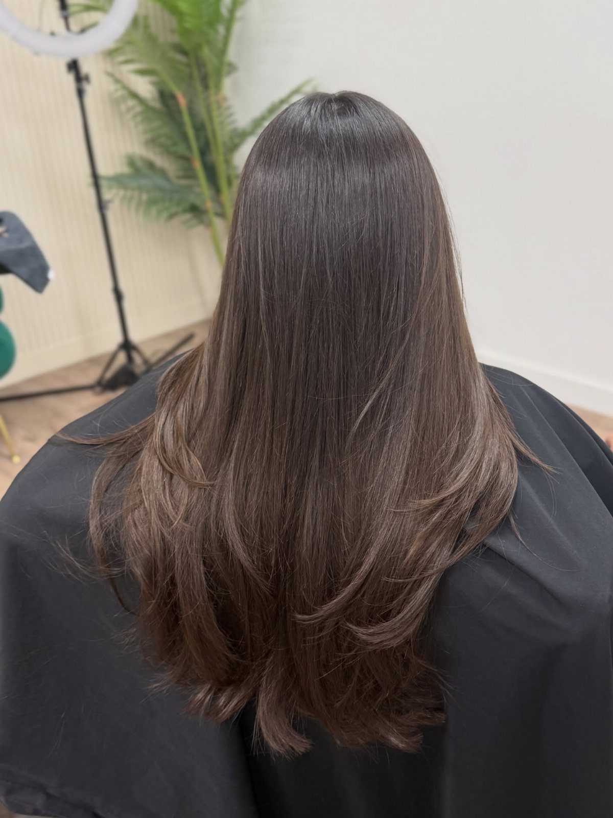 Long dark brown hair with subtle layers and softly curved ends