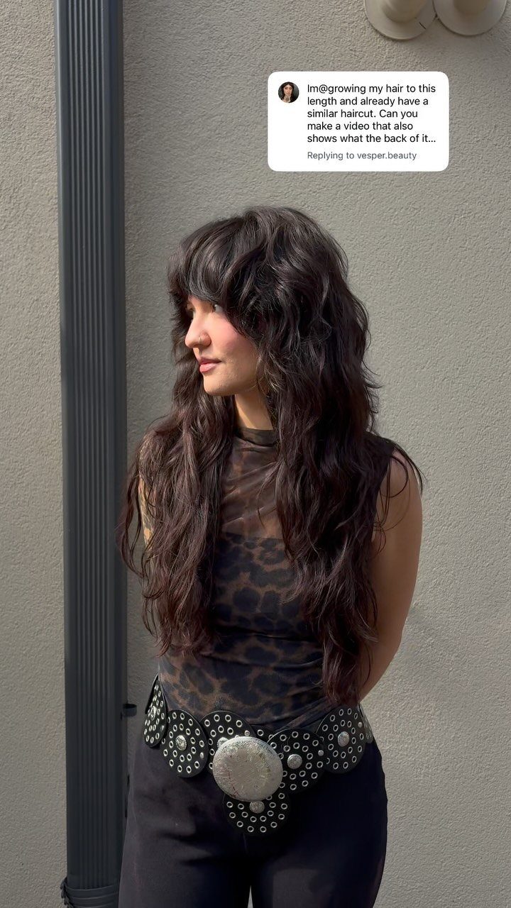 Woman with long, dark shag haircut and choppy, tousled layers