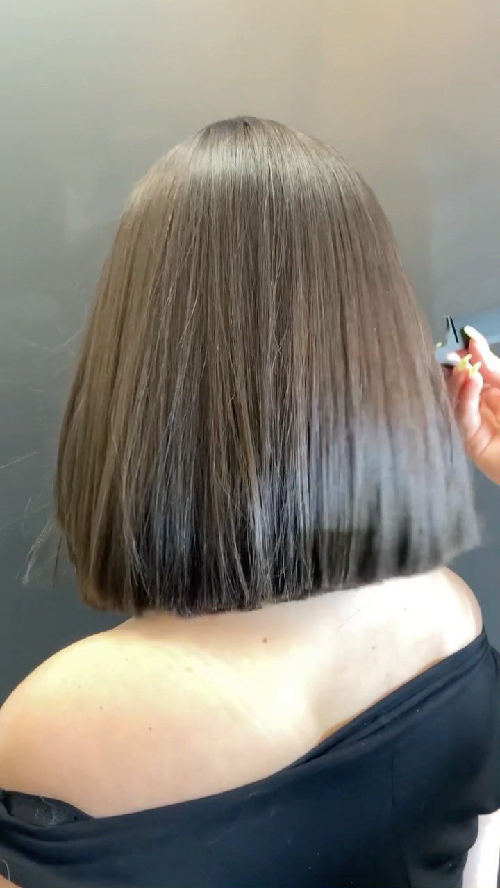 Straight ash-brown bob with a blunt, even edge shown from behind