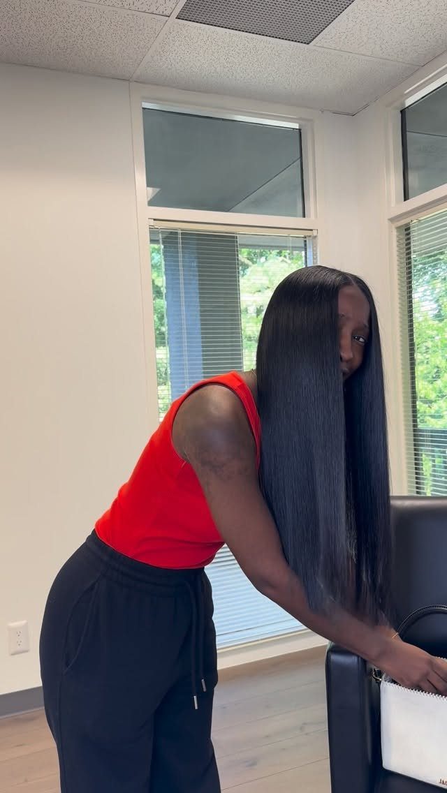 Long straight black hair hangs in a dense, even blunt edge