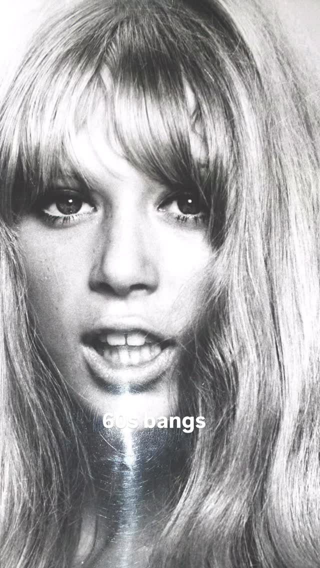 Woman with long straight hair and a retro parted fringe framing her face
