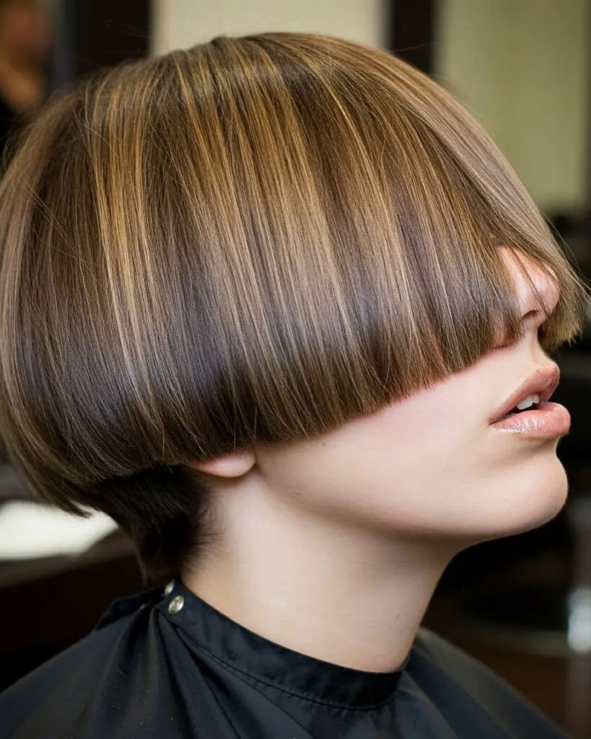 Brown bob with a thick, straight-across fringe covering the eyebrows