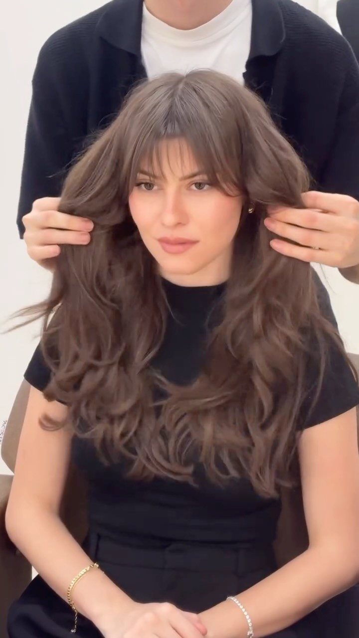 Woman with long brown hair showing a wispy, center-full bottleneck fringe