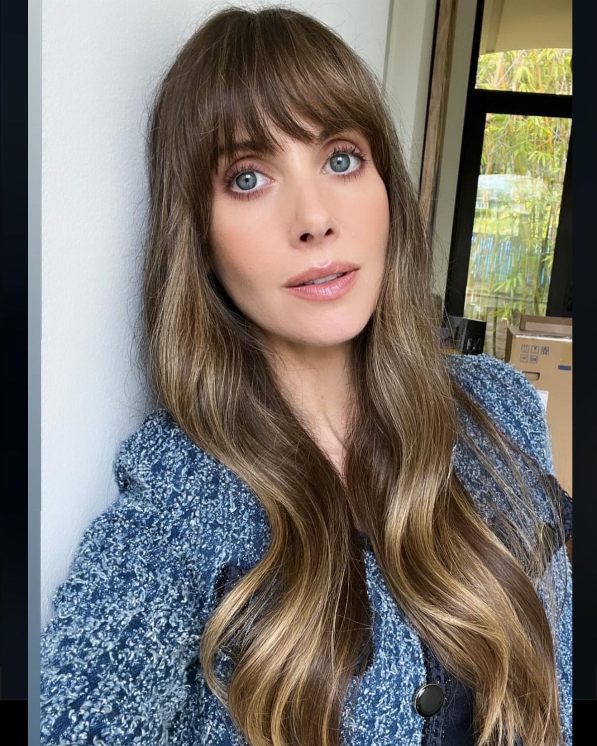 Woman with very long brown hair styled in soft, flowing textured waves