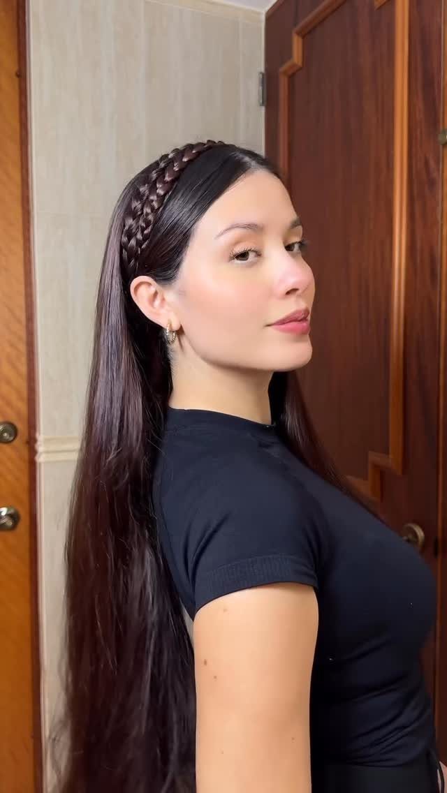 Woman with long dark hair wearing a braided headband