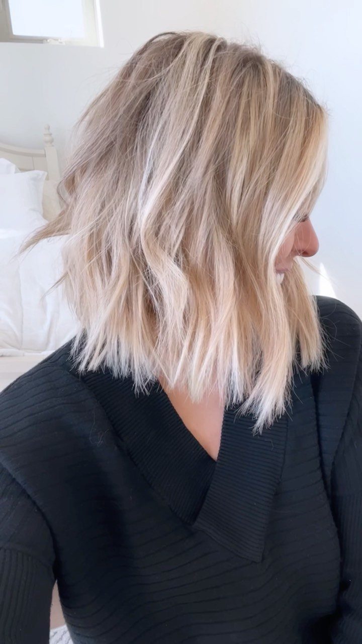 Shoulder-length blonde hair styled in relaxed, loose waves