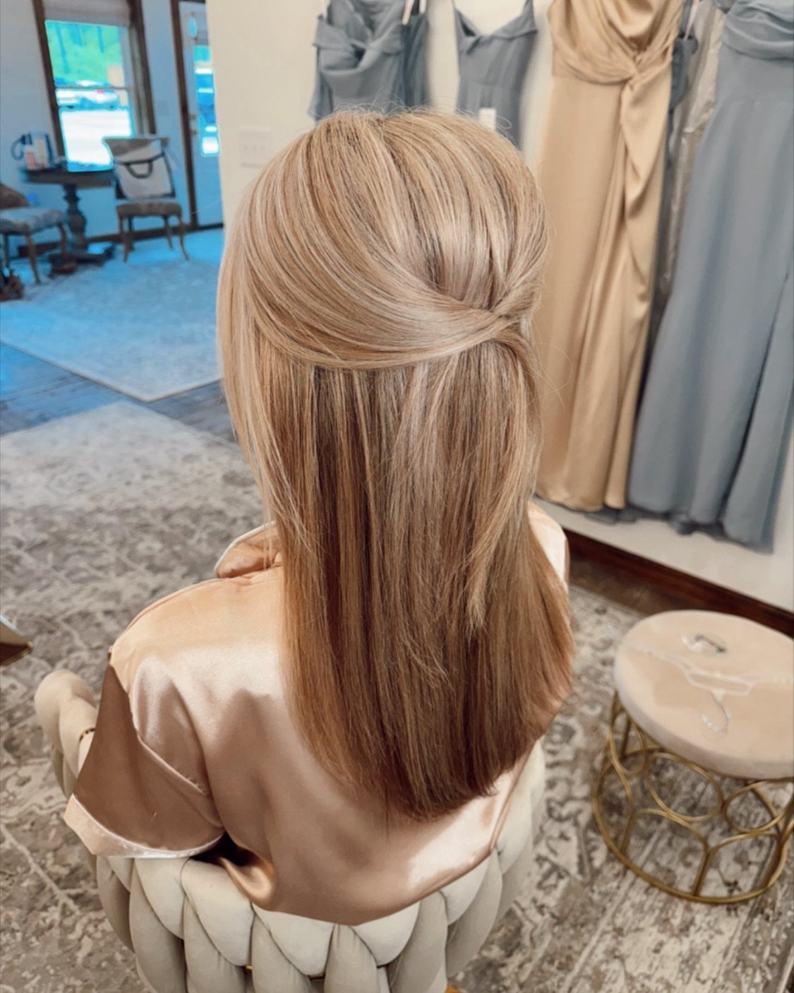 Long straight light brown hair swept back and pinned at the crown