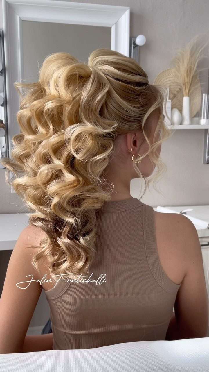 Blonde woman with a voluminous curled ponytail and twisted crown sections