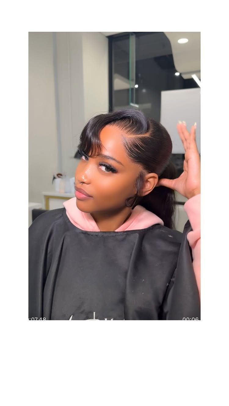 Woman showing a sleek ponytail framed by side-swept bangs