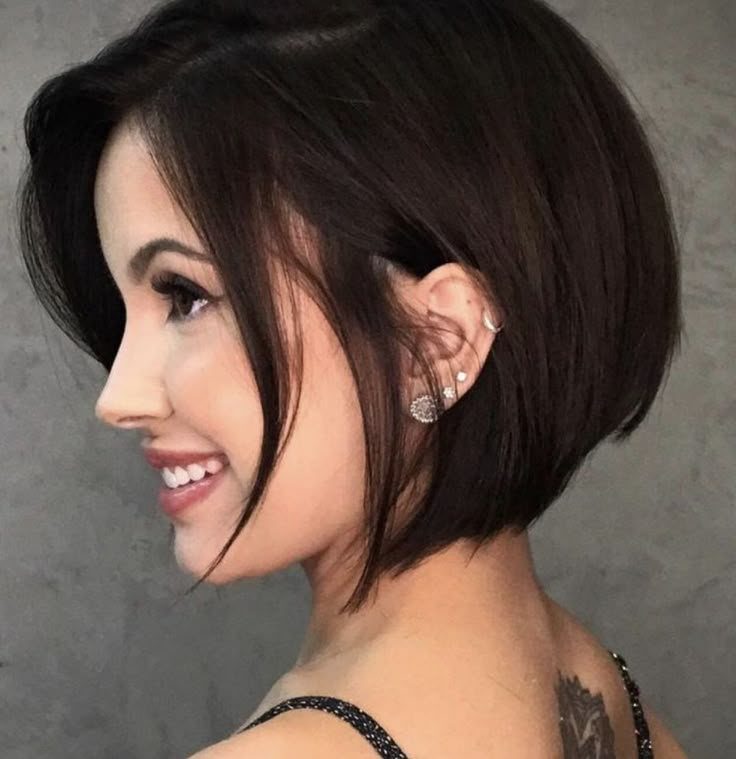 Woman showing a sleek dark jaw-length bob with a side part