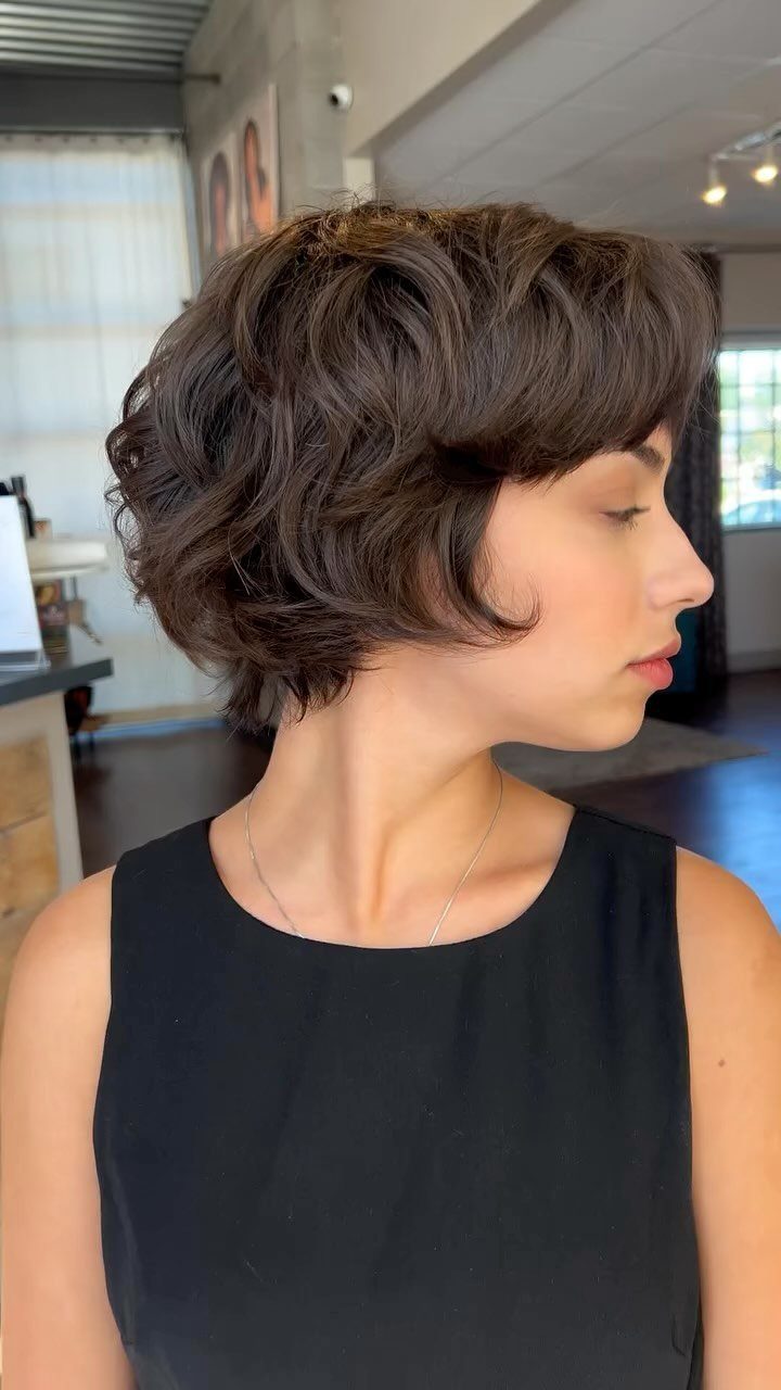 Rounded airy bixie with soft dark layers and a long side fringe