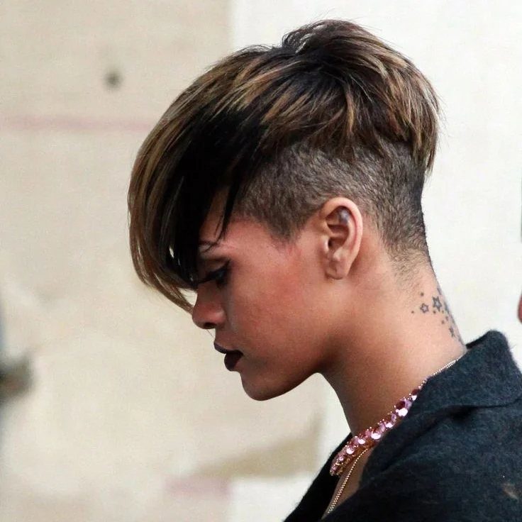 Short layered brown haircut with a long side-swept fringe and closely cropped sides