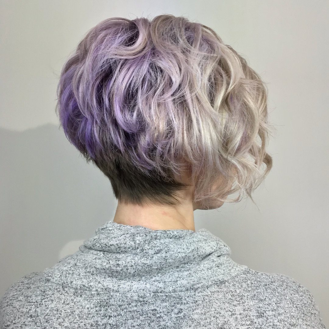 Stacked bob with a lifted crown, lavender roots, and longer blonde curls