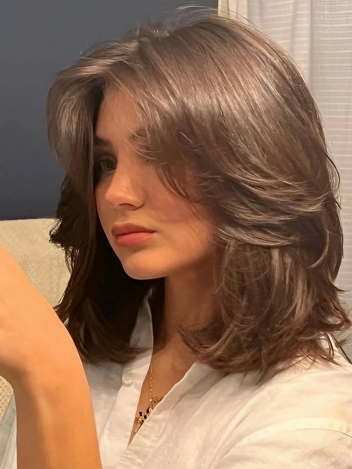 Woman with a voluminous brown shoulder-length bob and face-framing layers