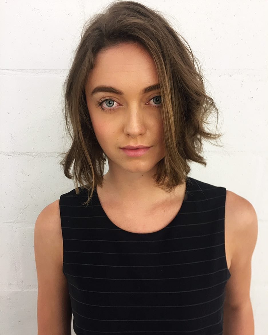 Woman with a chin-length brown bob styled in soft, layered waves
