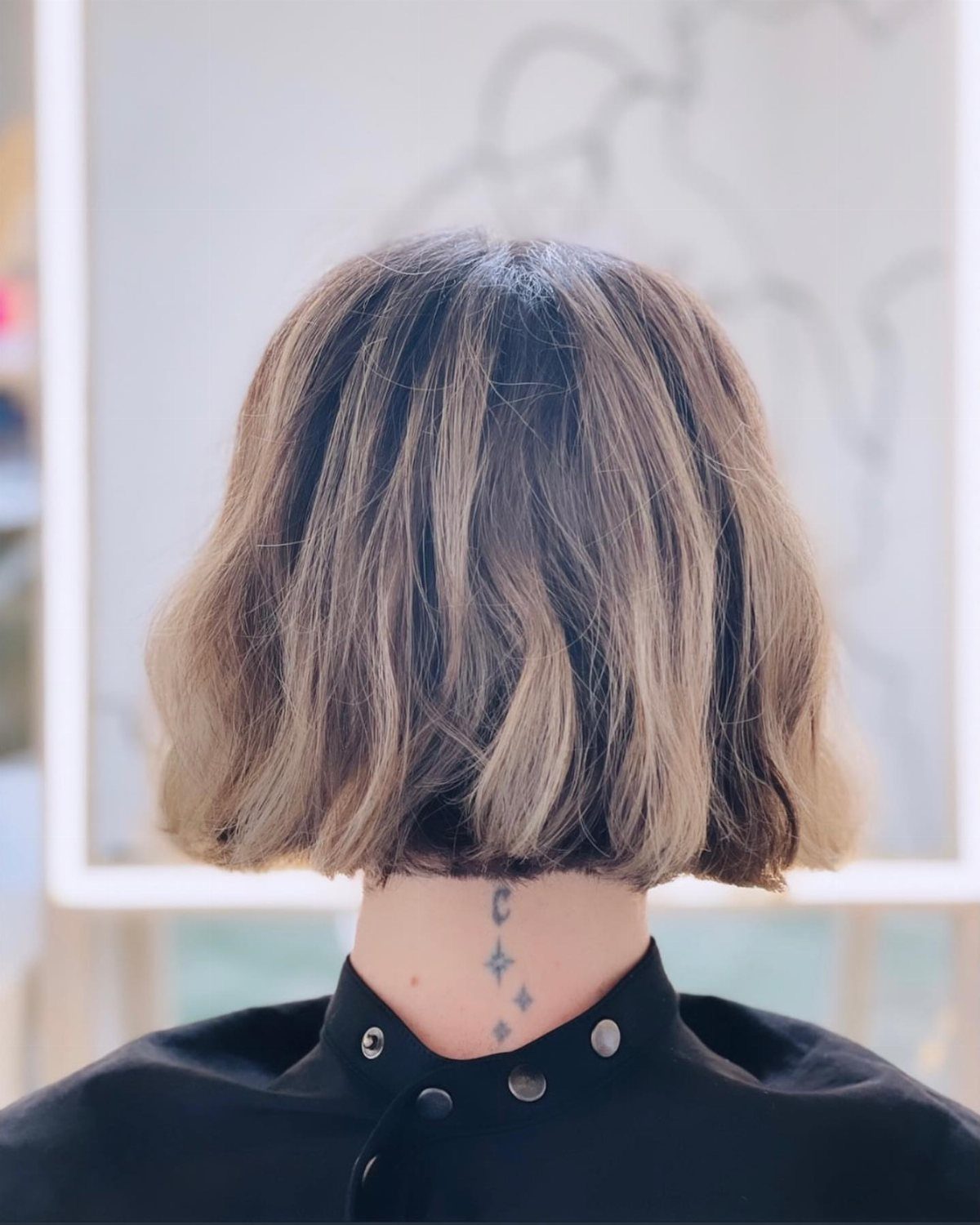 Short air-dried textured bob with wavy layered brown and blonde hair