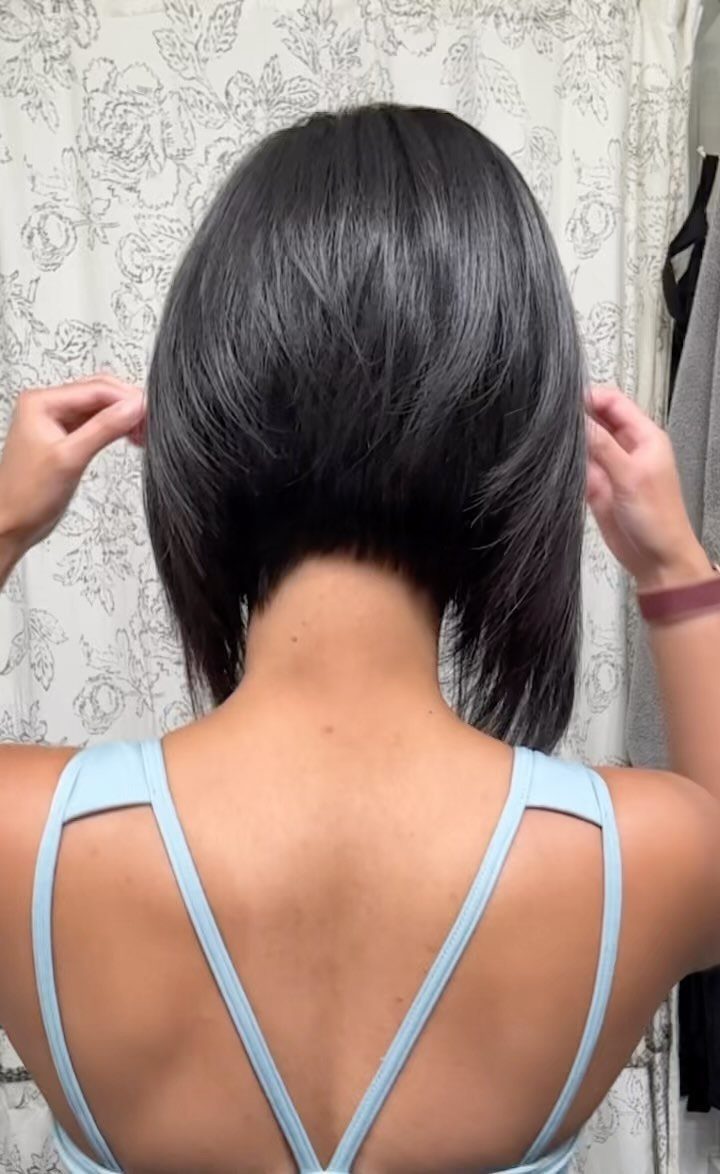 Dark angled bob shown from behind, with tapered nape and longer sides