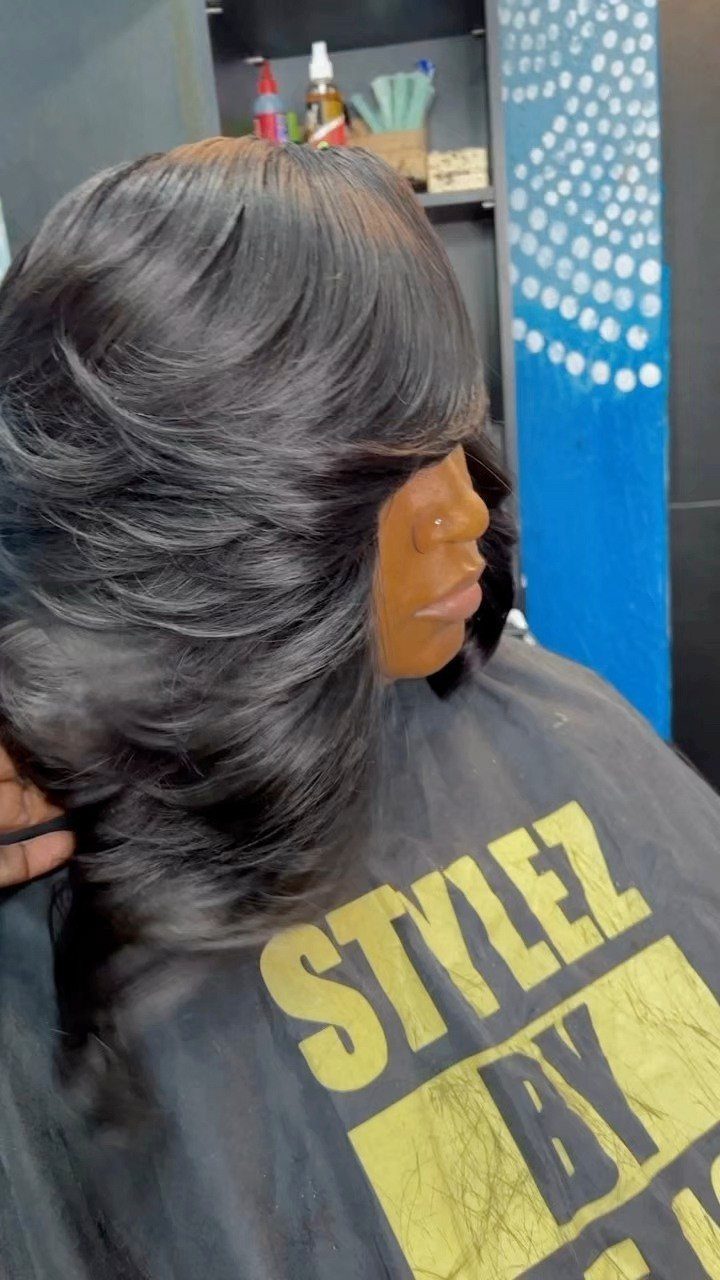 Side profile showing dark gray feathered bob with airy layered ends