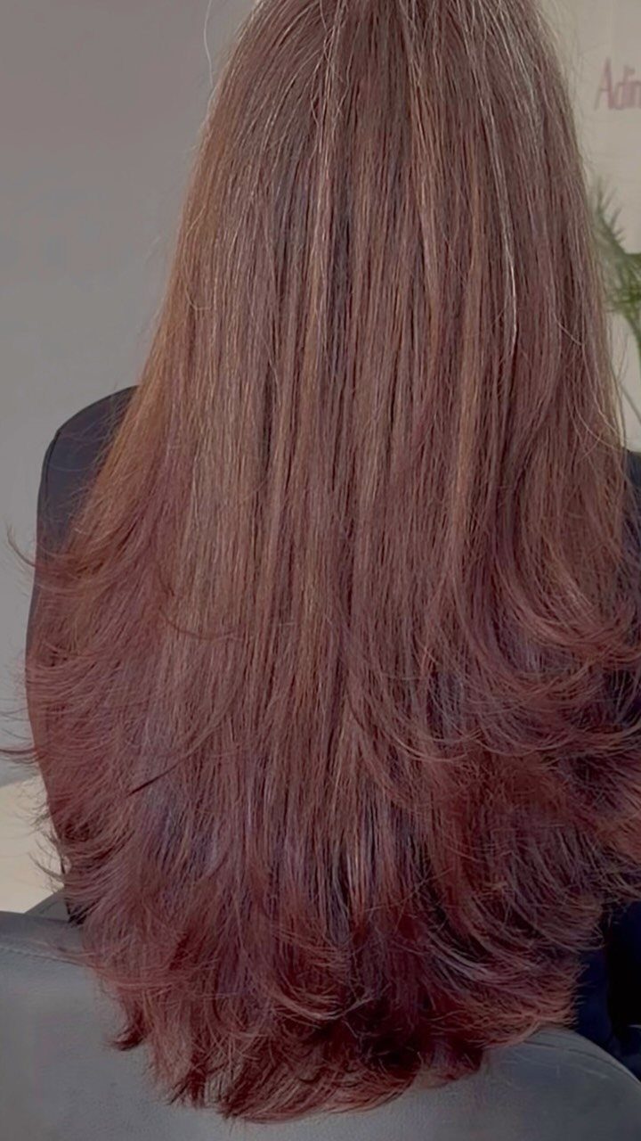 Long reddish-brown hair with layered lengths and feathered ends