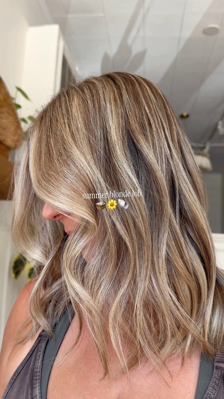Highlighted blonde long bob with dark roots and layered ends
