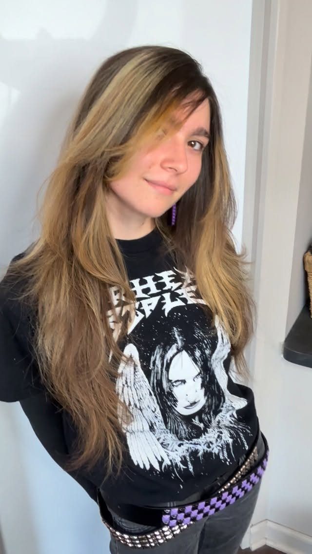 Young woman with long highlighted hair and side-swept bangs