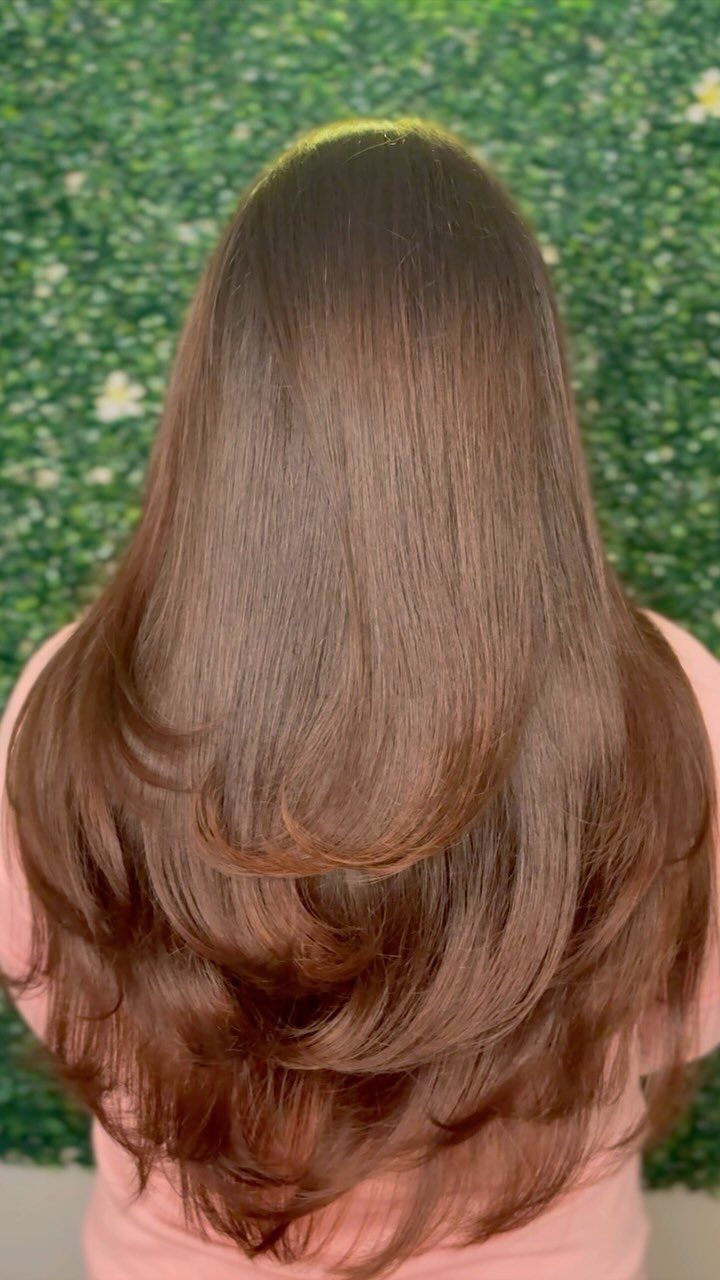 Long brown hair showing softly curved U-shaped layers and feathered ends