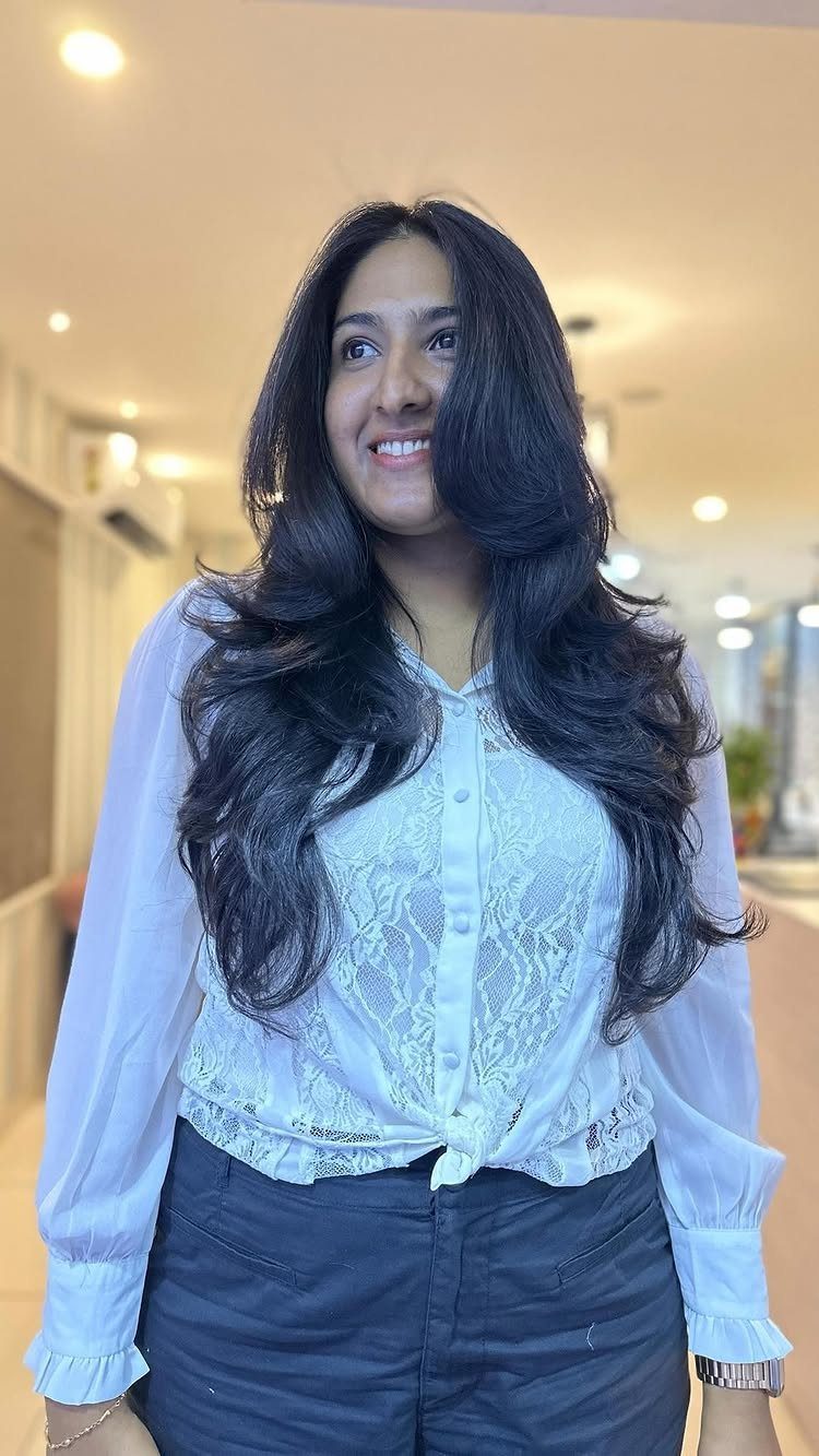 Woman showing long dark hair with voluminous angled front layers