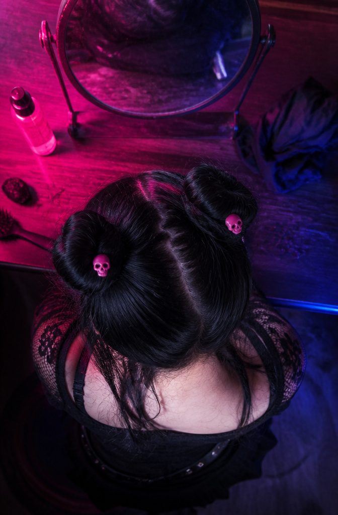High space buns on both sides of the head with pink skull clips